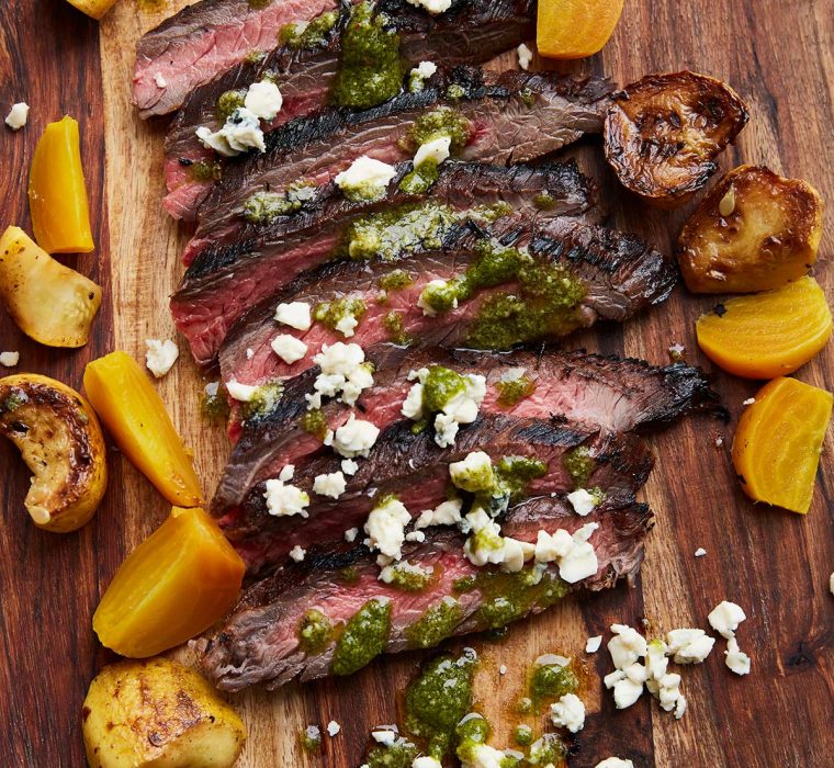 Latin-style flank steak on wood plank catering image