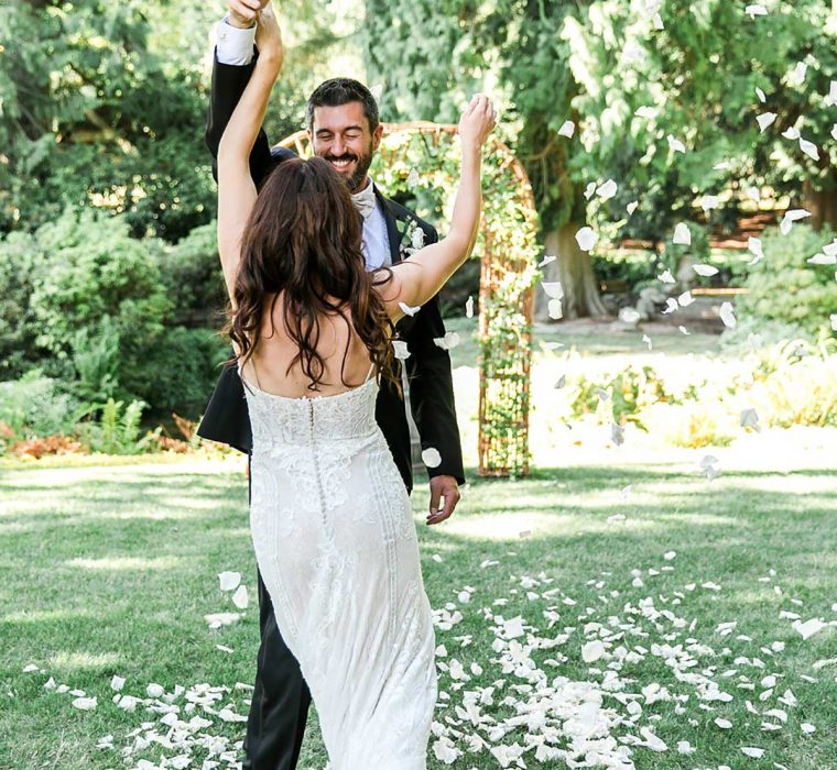 Wedding couple dancing on rose petals at wedding