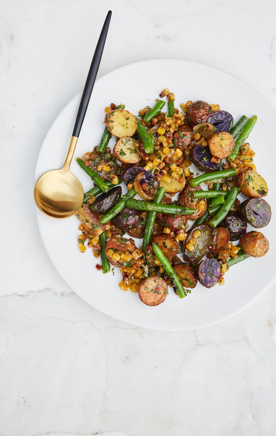 Roasted Jewel Potatoes With green beans and gold flatware