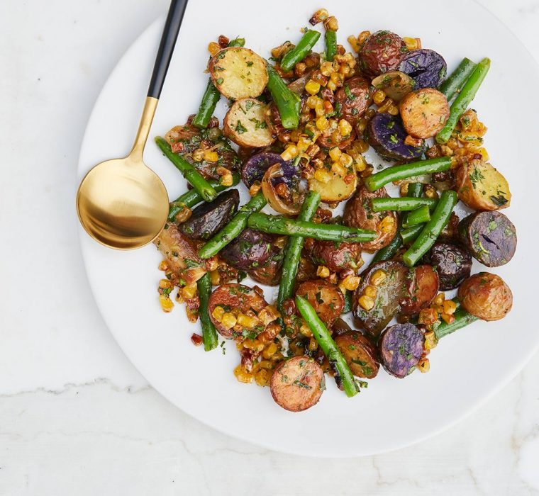 Roasted Jewel Potatoes With green beans and gold flatware