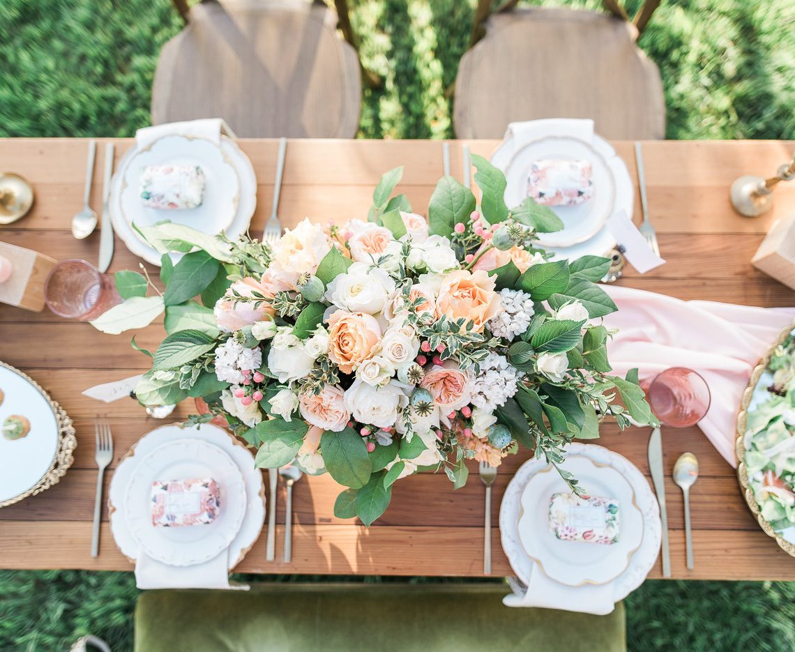 Garden wedding tablescape with antique china and peach and white flowers
