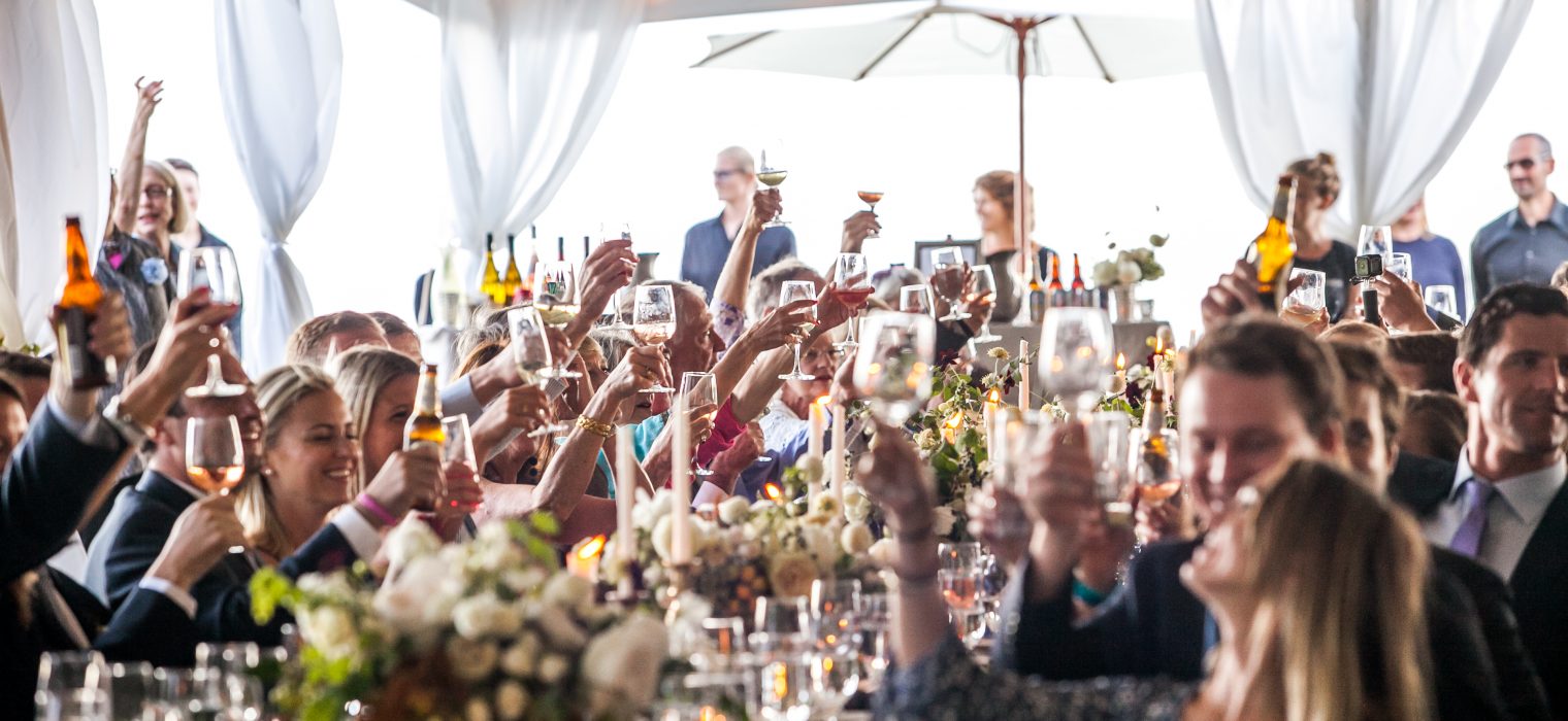 Wedding toast under white tent in the Pacific Northwest