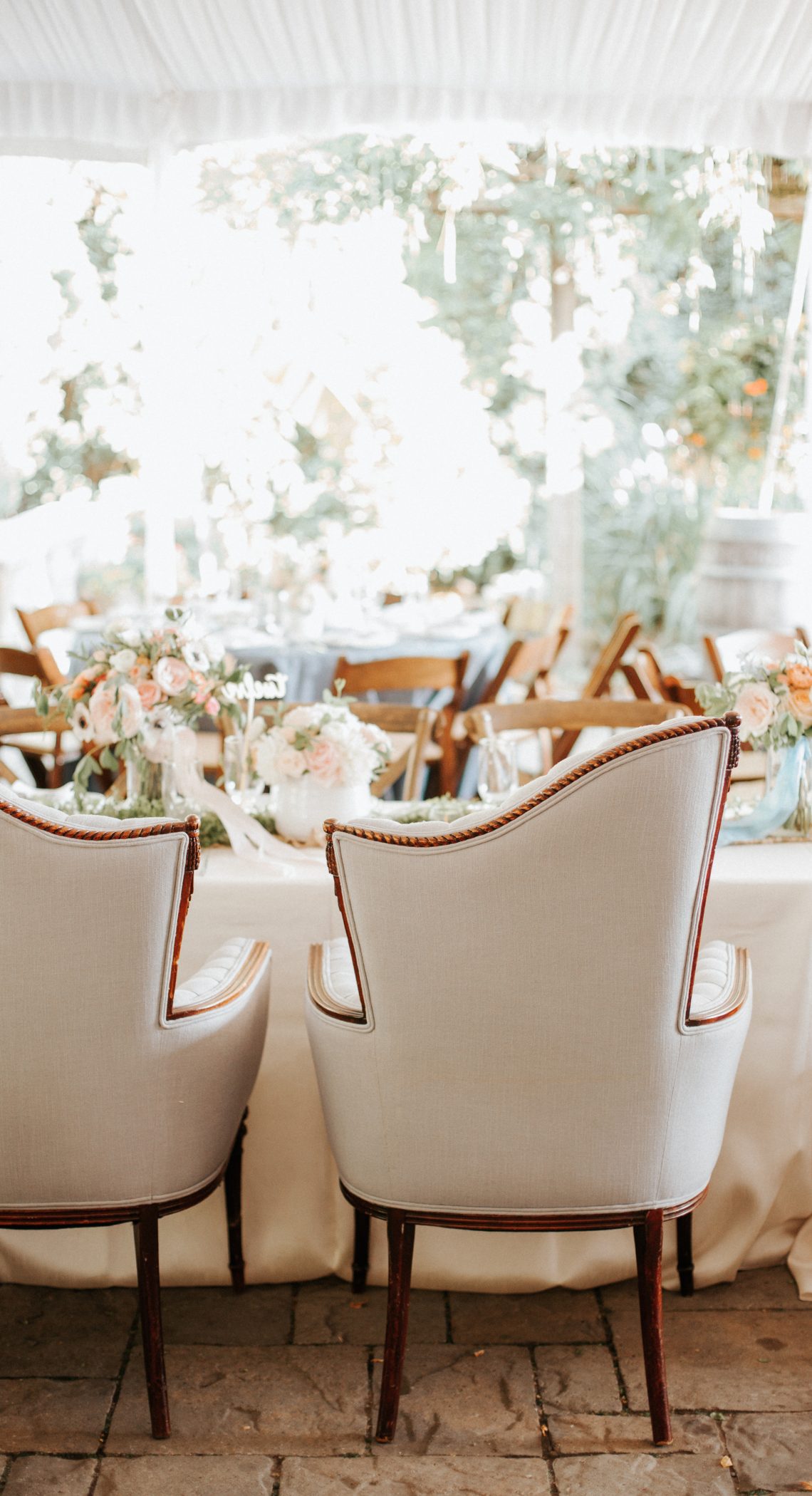 Wedding table with white chairs in tent