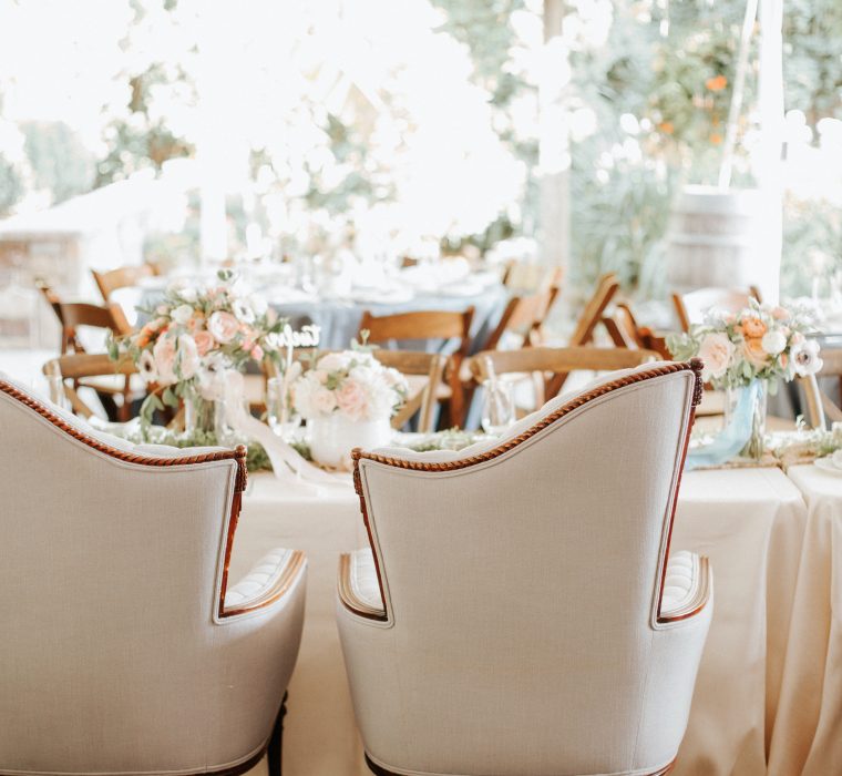 Wedding table with white chairs in tent
